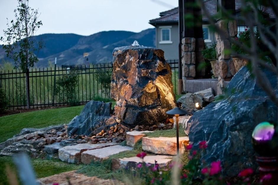 Boulder water feature with landscape lighting