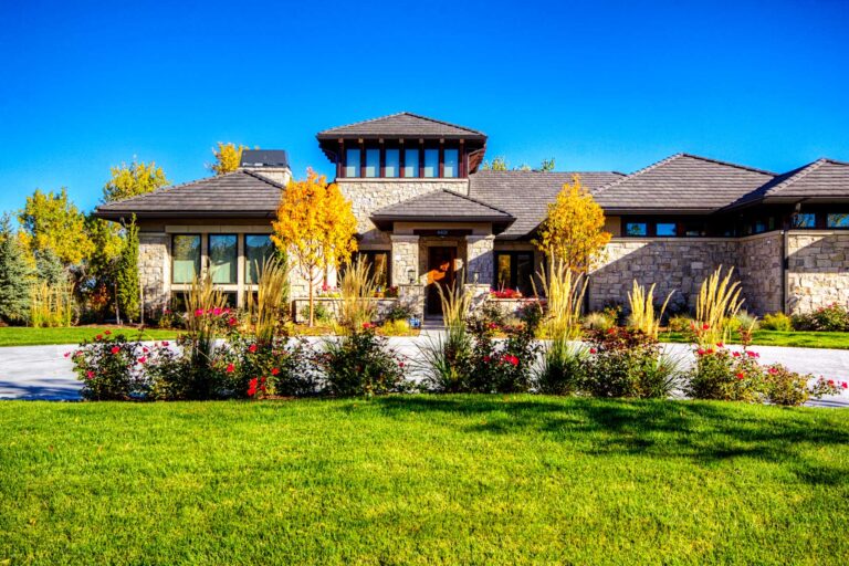 Manicured front entrance with seasonal flowers and professional landscape maintenance