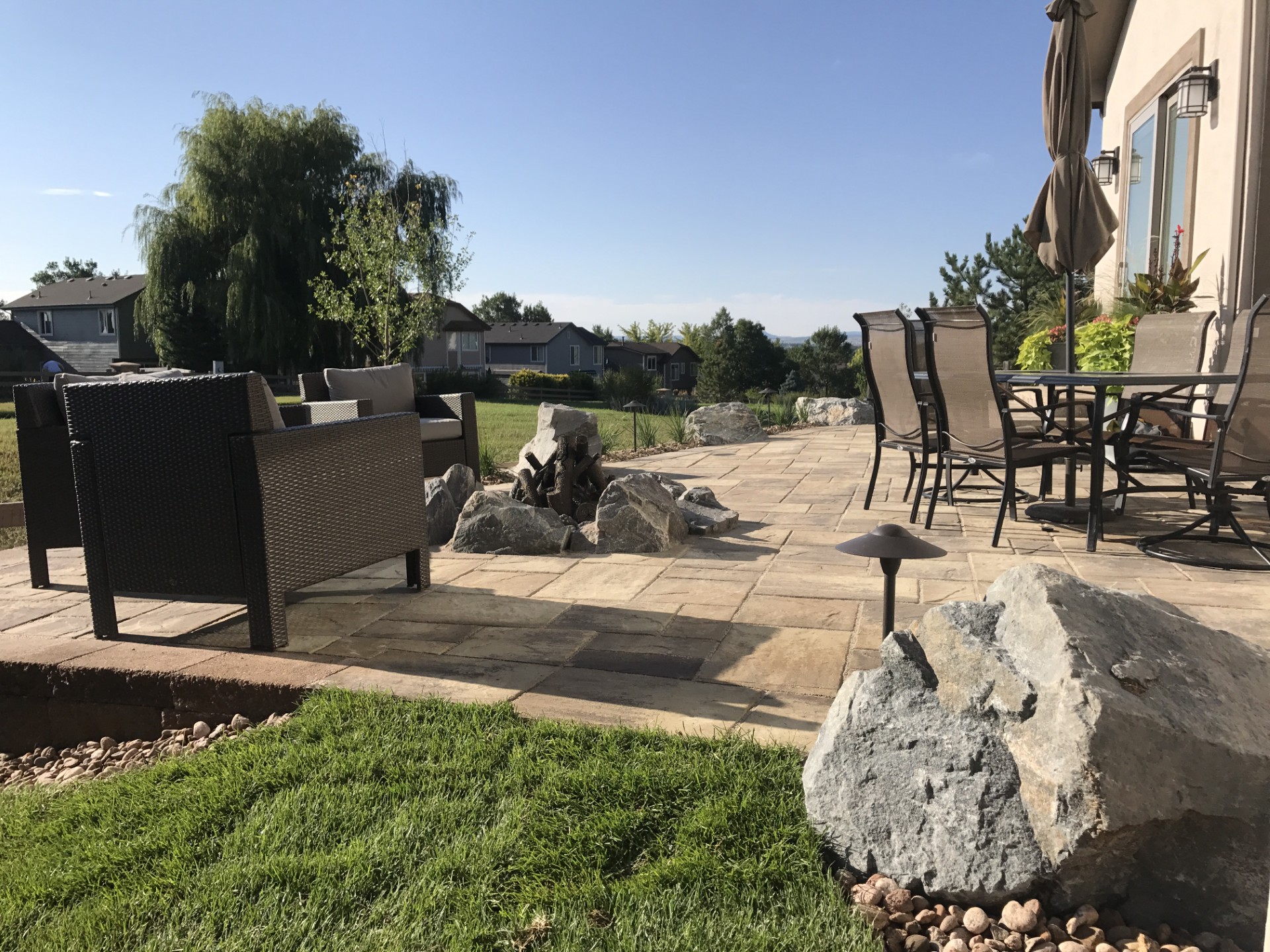 Outdoor patio with natural stone and boulder accents